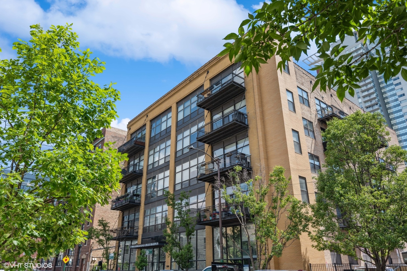 a tall building with trees in front of it