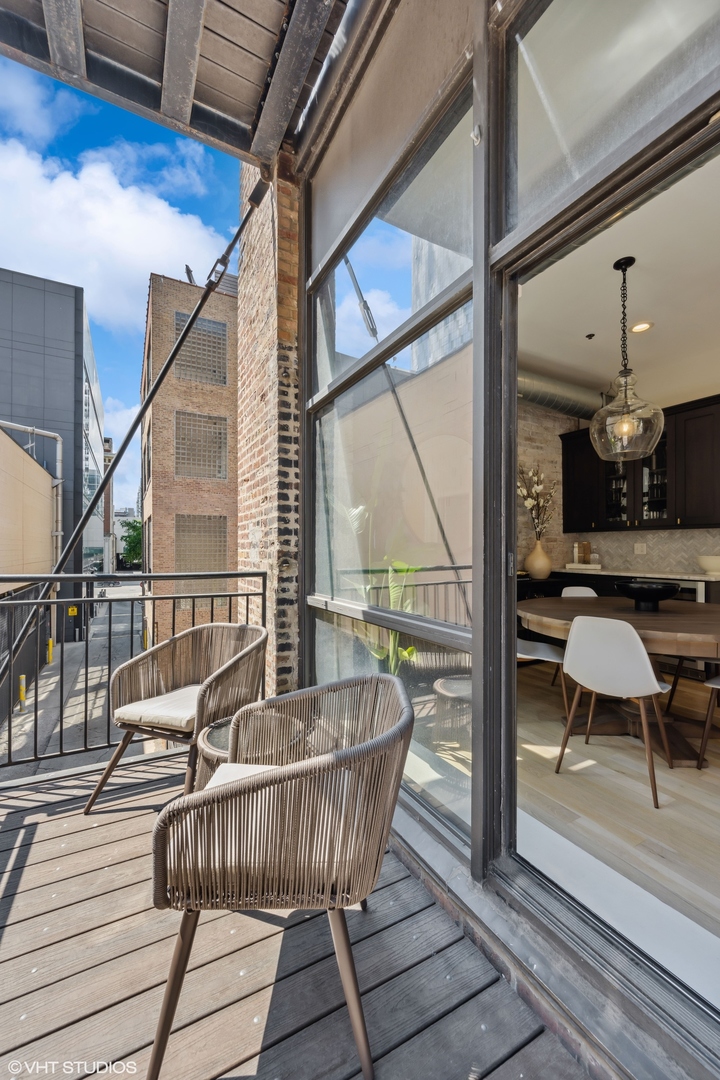 23 North Green Street, Unit 203 Chicago, IL 60607 - Photo 15 of 15 a living room with furniture and a large window