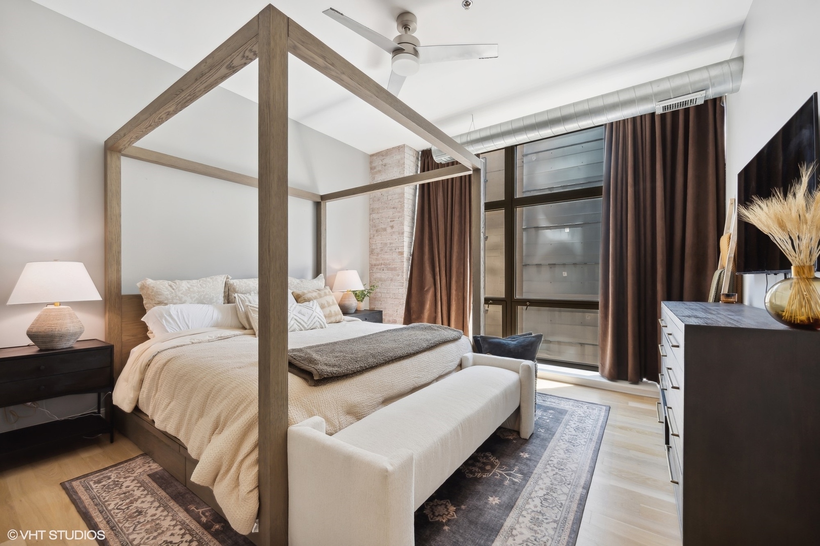 23 North Green Street, Unit 203 Chicago, IL 60607 - Photo 8 of 15 a bedroom with a bed window and a flat screen tv