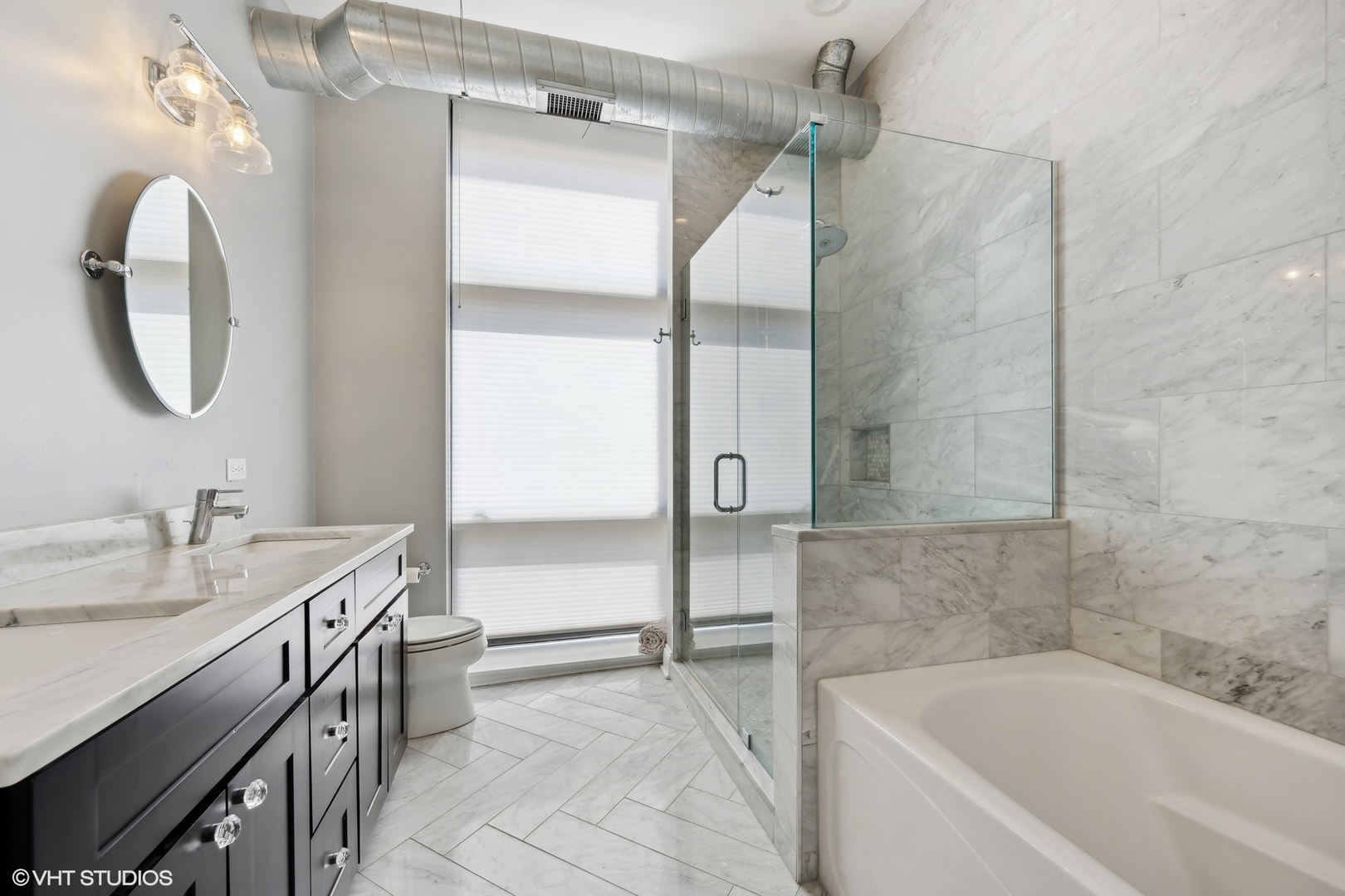 23 North Green Street, Unit 203 Chicago, IL 60607 - Photo 9 of 15 a bathroom with a tub sink and mirror