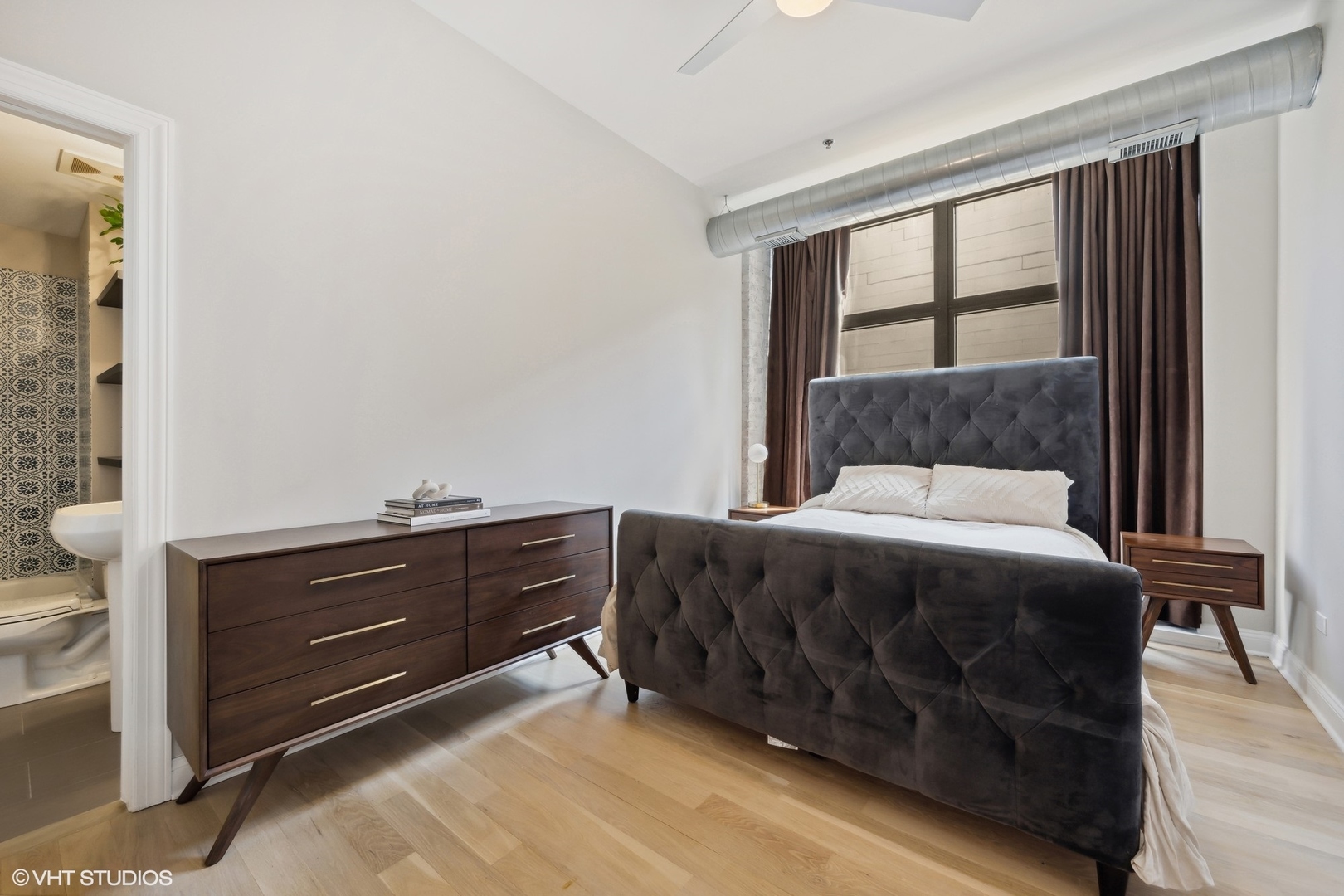 23 North Green Street, Unit 203 Chicago, IL 60607 - Photo 10 of 15 a bedroom with a bed and a window