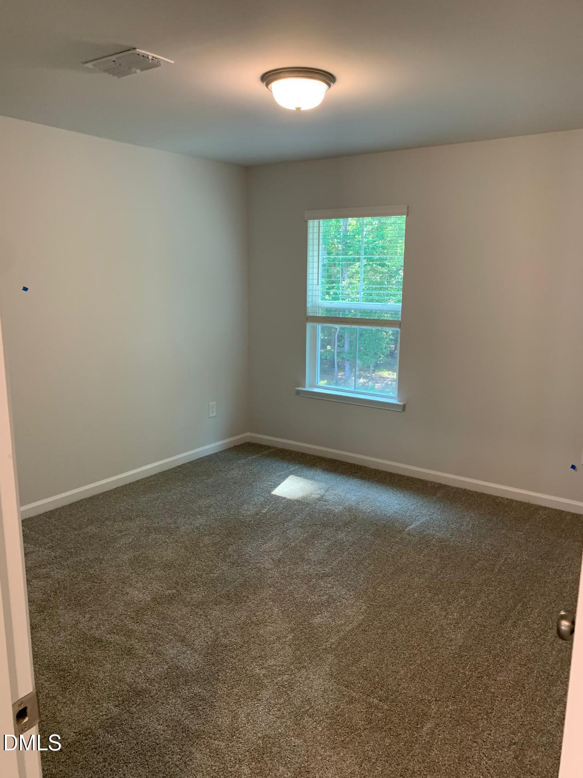 233 Broomside Avenue Raleigh, NC 27603 - Photo 15 of 18 an empty room with a window