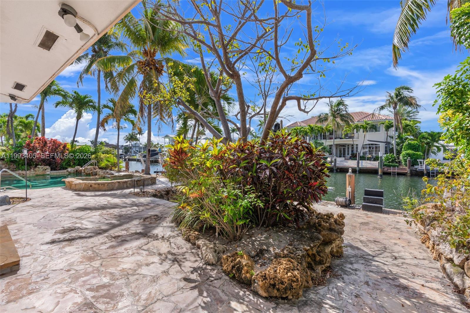 2858 Northeast 33rd Street Lighthouse Point, FL 33064 - Photo 15 of 24 a backyard of a house with lots of green space