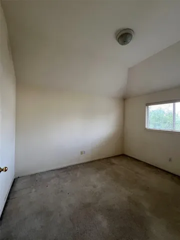 an empty room with a empty space and windows