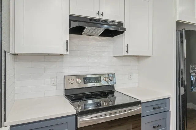 a kitchen with a stove and a microwave
