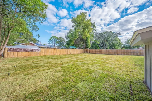 a view of yard with swimming pool and green space