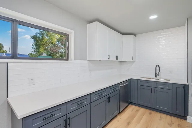 a kitchen with a sink and cabinets