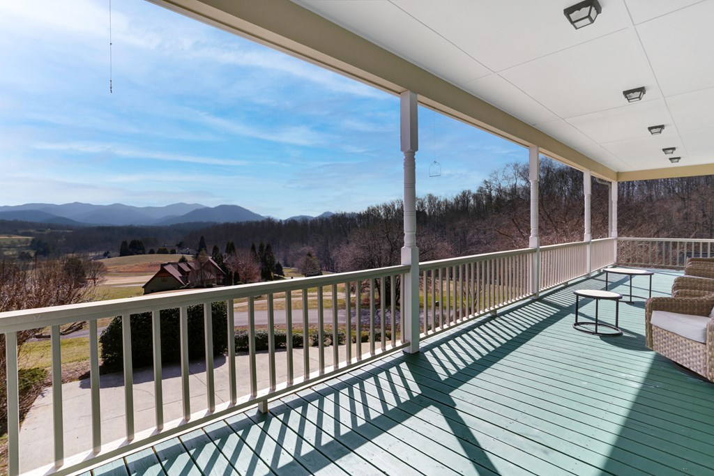18 Foxfire Court Hayesville, NC 28904 - Photo 28 of 41 a view of a balcony with wooden floor next to a yard