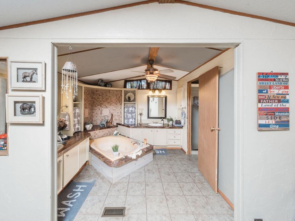 196 Perch Road Bowie, TX 76230 - Photo 11 of 30 a large white kitchen with a large window