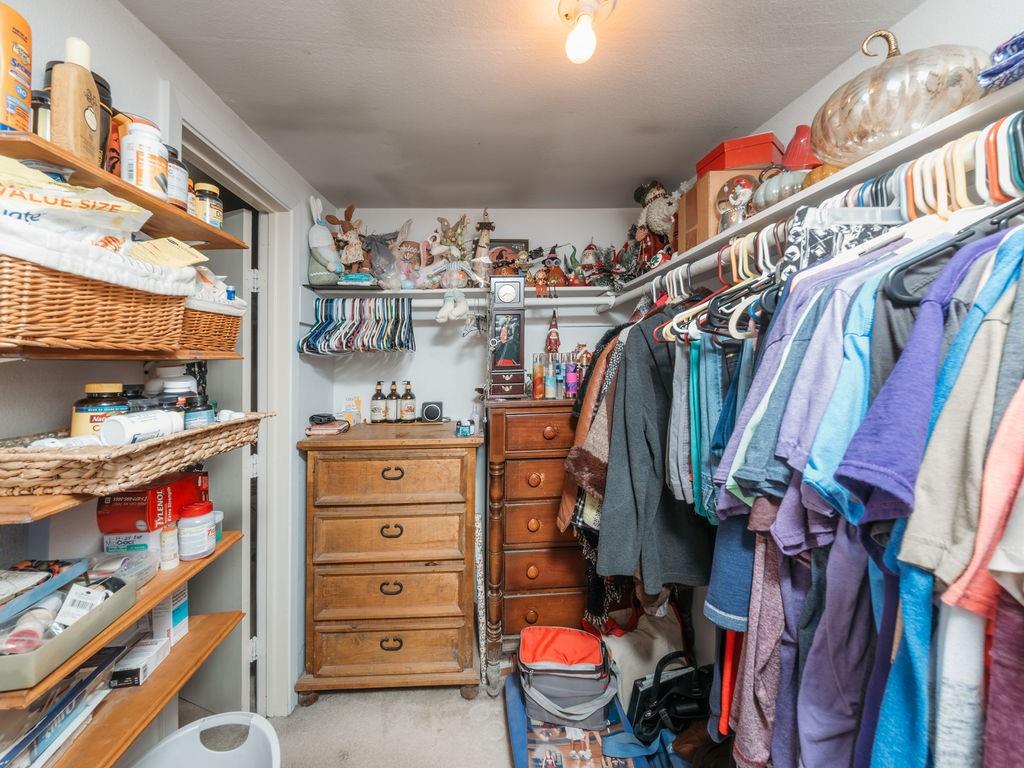 196 Perch Road Bowie, TX 76230 - Photo 16 of 30 a view of walk in closet with clothes and shoes