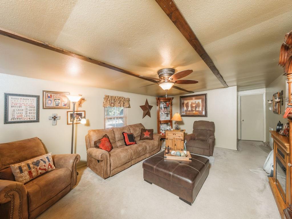 196 Perch Road Bowie, TX 76230 - Photo 18 of 30 a living room with furniture and a flat screen tv