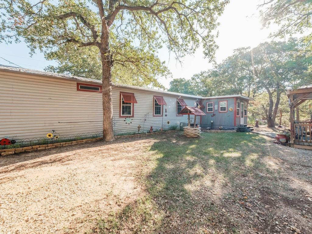 196 Perch Road Bowie, TX 76230 - Photo 24 of 30 a view of a house with a yard