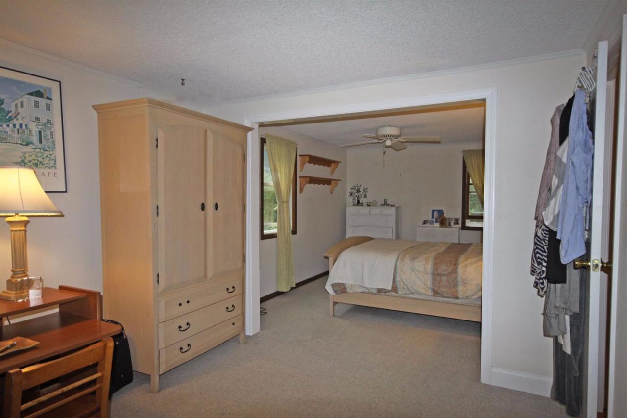140 Captain Samadrus Road Cotuit, MA 02635 - Photo 11 of 18 a bed room with a bed and a lamp
