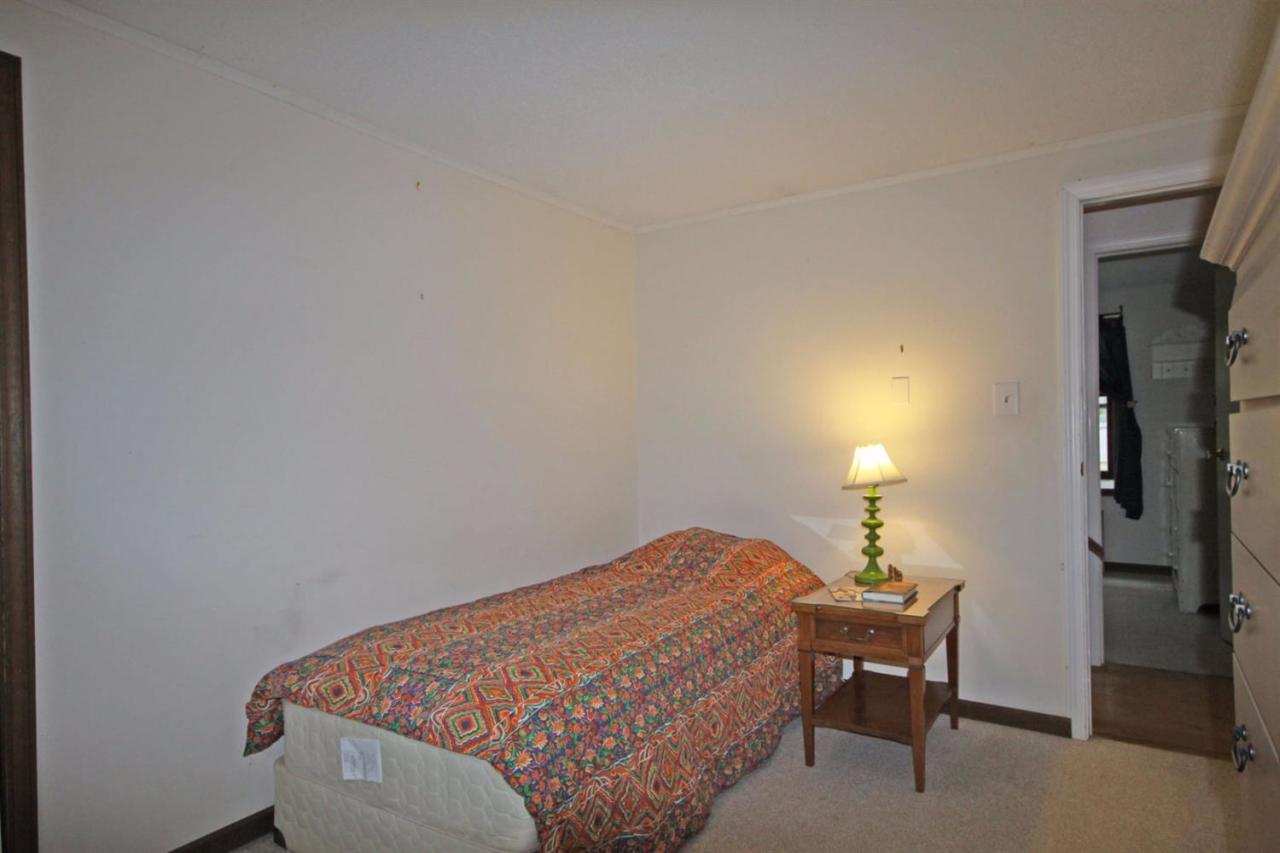 140 Captain Samadrus Road Cotuit, MA 02635 - Photo 13 of 18 a bedroom with a bed and a lamp on table