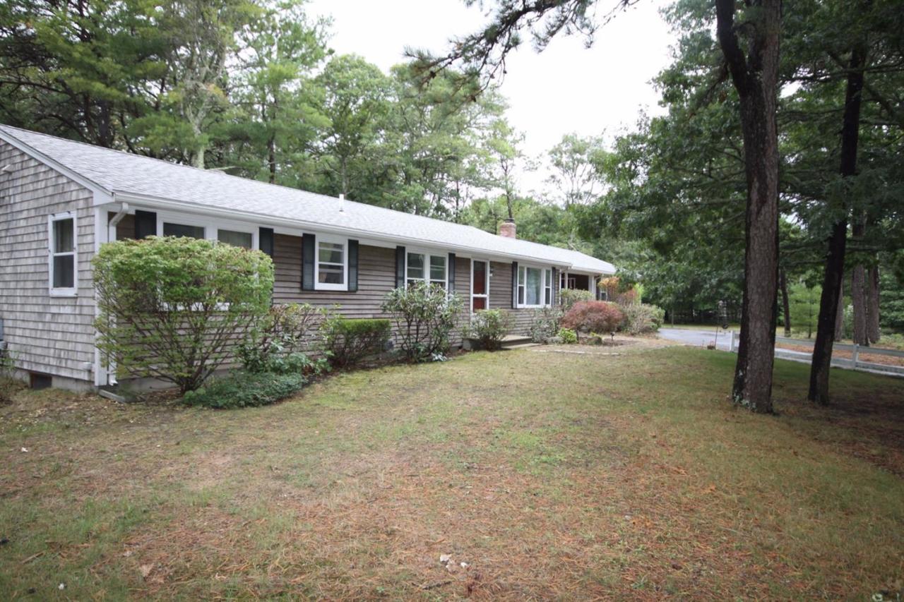 140 Captain Samadrus Road Cotuit, MA 02635 - Photo 16 of 18 a view of a house with backyard and sitting area