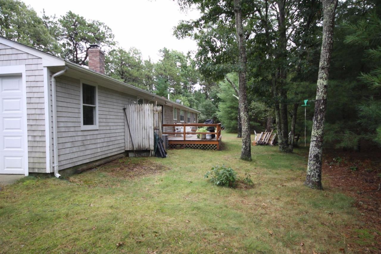 140 Captain Samadrus Road Cotuit, MA 02635 - Photo 17 of 18 a view of a house with a yard