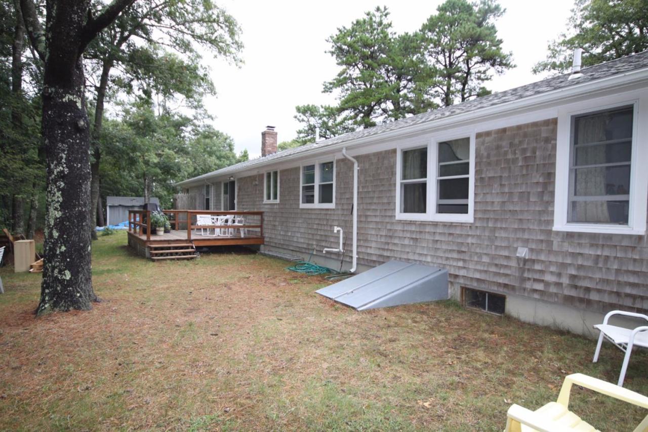 140 Captain Samadrus Road Cotuit, MA 02635 - Photo 18 of 18 a view of a house with backyard and a tree