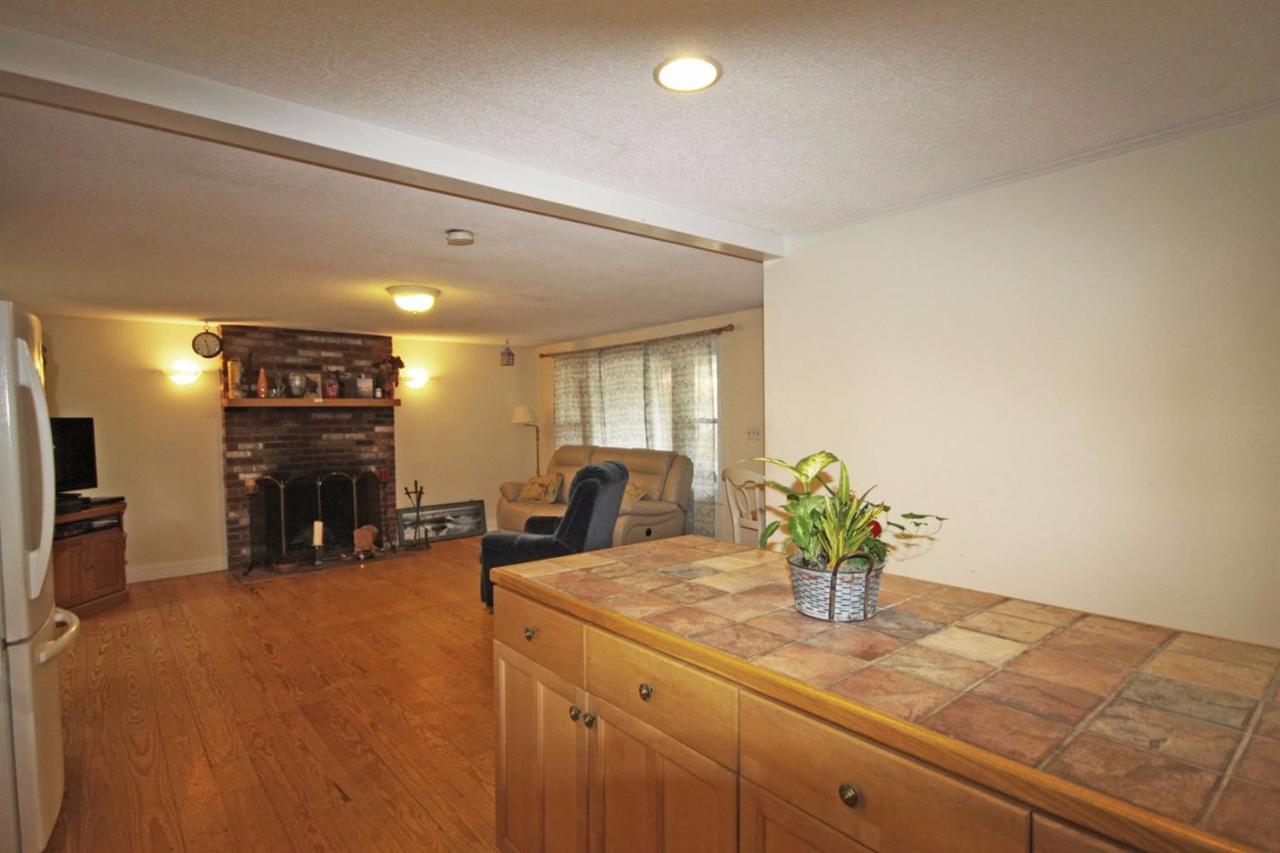 140 Captain Samadrus Road Cotuit, MA 02635 - Photo 4 of 18 a kitchen with a sink and potted plant