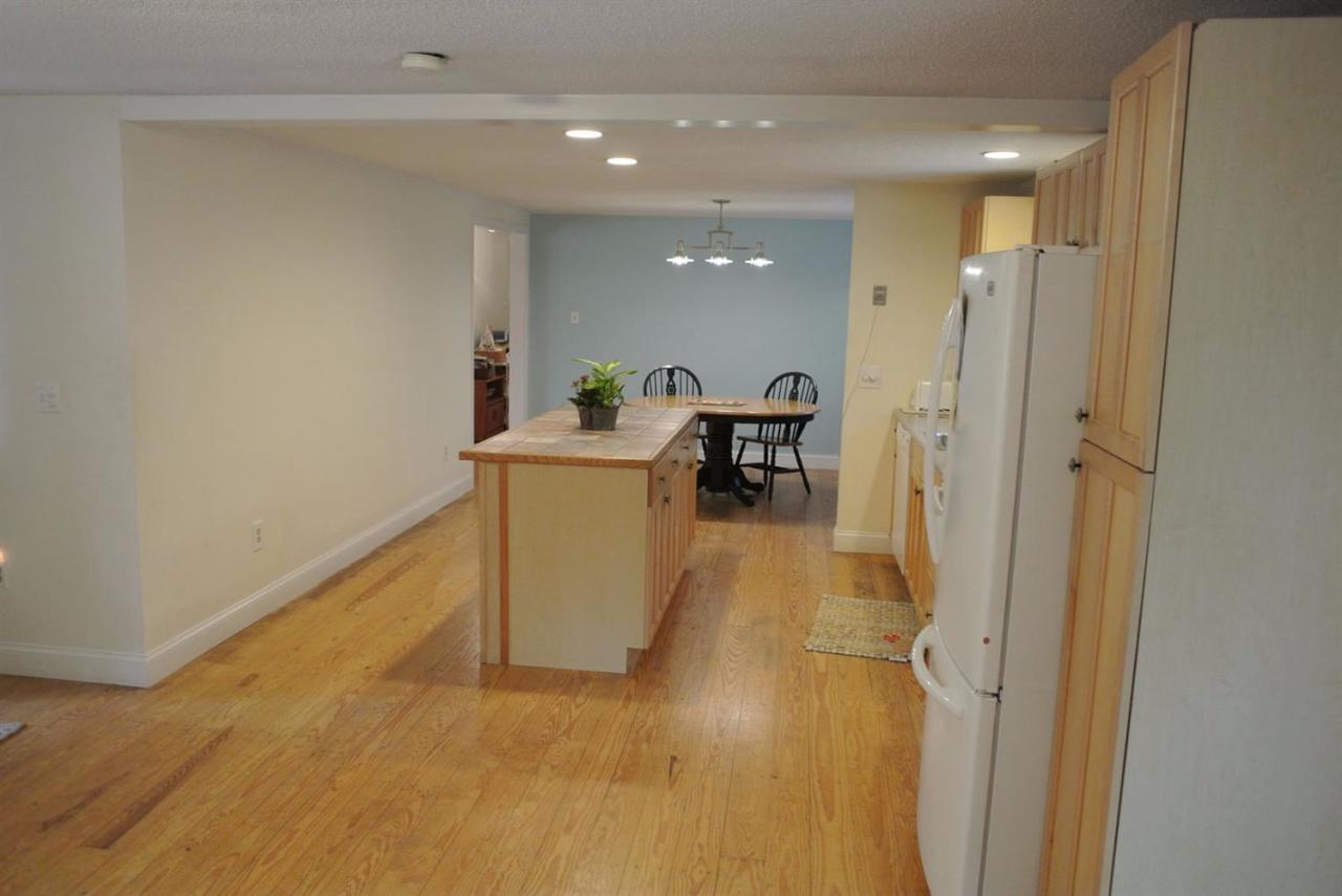140 Captain Samadrus Road Cotuit, MA 02635 - Photo 5 of 18 a view of a hallway with dining area and chandelier