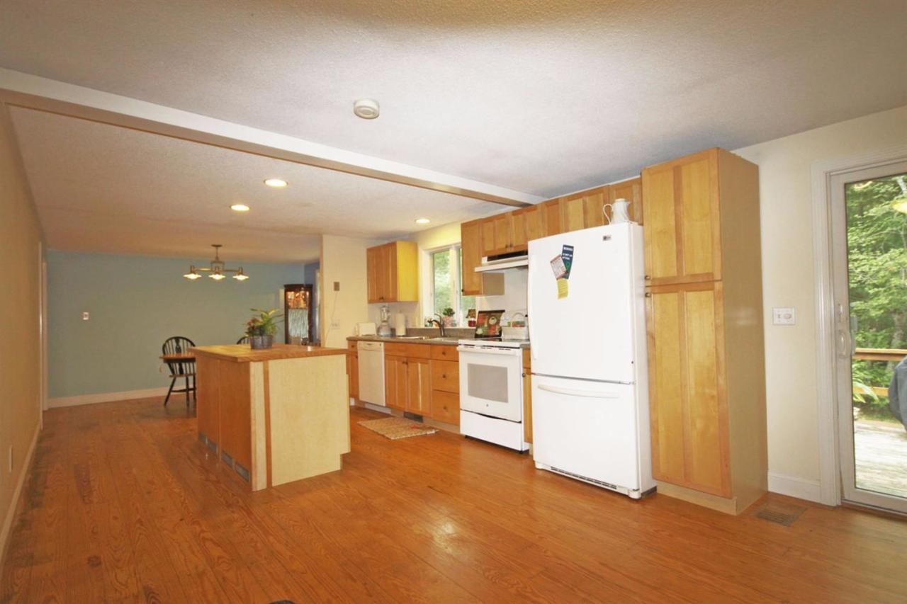 140 Captain Samadrus Road Cotuit, MA 02635 - Photo 6 of 18 a view of kitchen with furniture and refrigerator