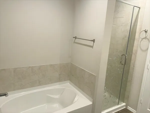 a bath tub sitting next to a shower
