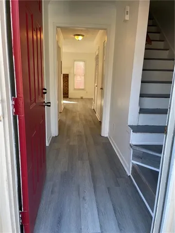 a view of a hallway with wooden floor and entryway