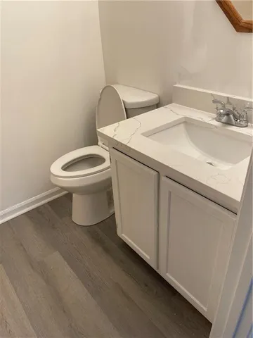 a white toilet sitting next to a bathroom sink