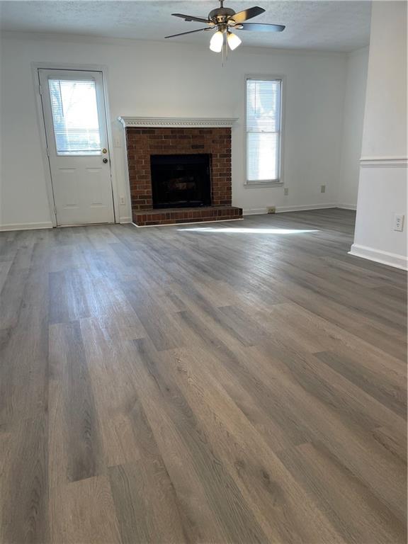 167 Walter Way Stone Mountain, GA 30083 - Photo 6 of 21 an empty room with wooden floor a fireplace and windows