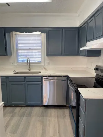 a kitchen with a sink cabinets and a window