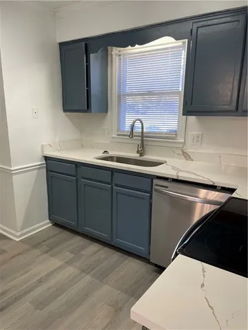 a kitchen with a sink and a mirror