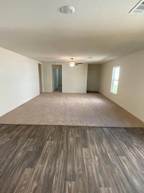 521 Locksley Cove Jarrell, TX 76537 - Photo 3 of 9 an empty room with wooden floor and windows