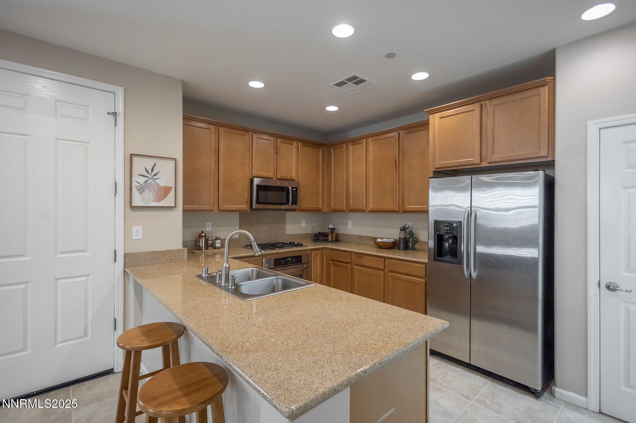 1715 Dark Horse Road, Unit B Reno, NV 89521 - Photo 11 of 39 a kitchen with stainless steel appliances granite countertop a refrigerator a stove microwave and cabinets