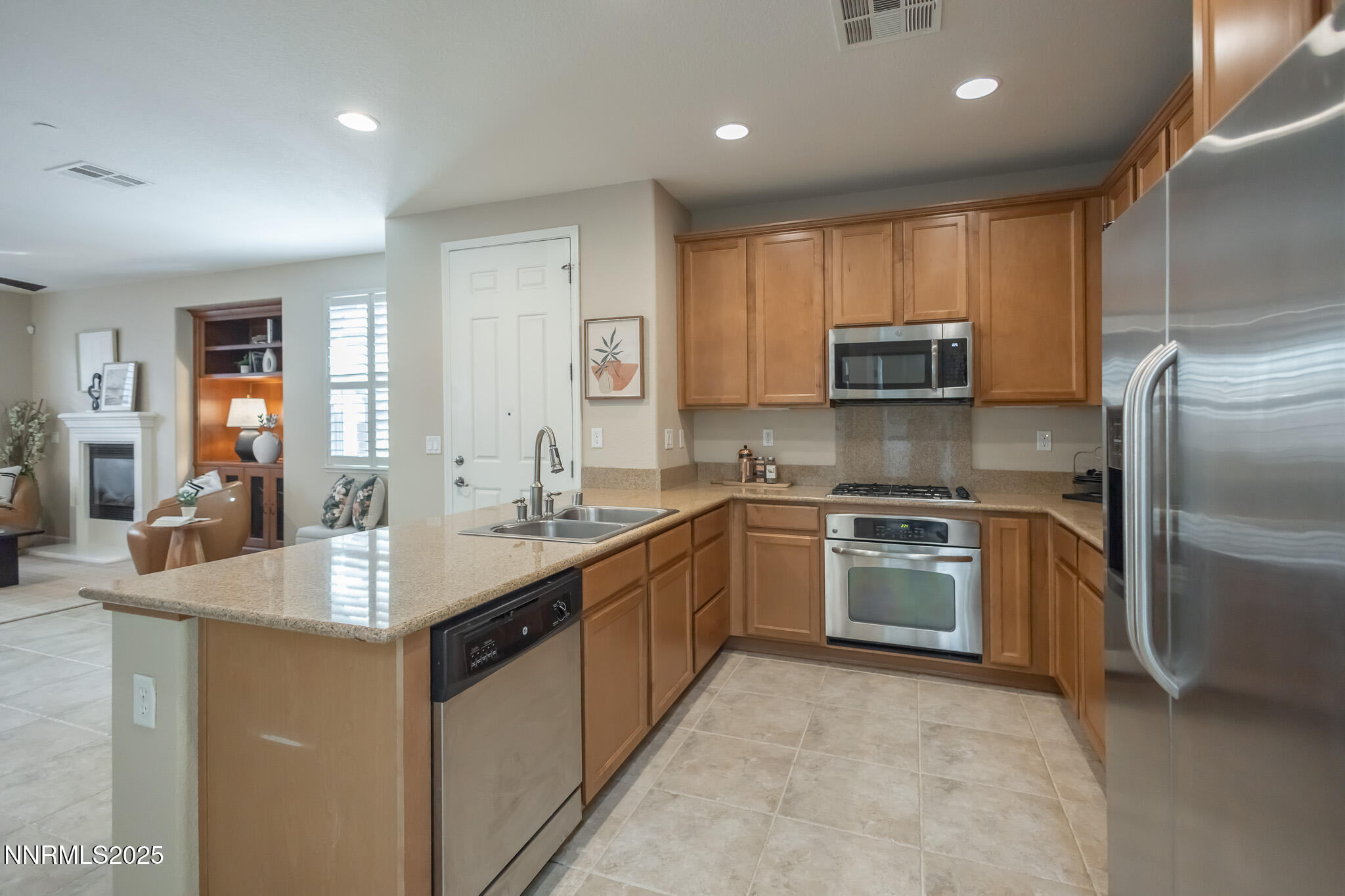 1715 Dark Horse Road, Unit B Reno, NV 89521 - Photo 12 of 39 a kitchen with kitchen island granite countertop a sink stove and refrigerator