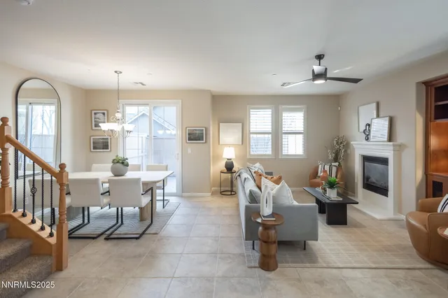 a living room with furniture chess table and a fireplace