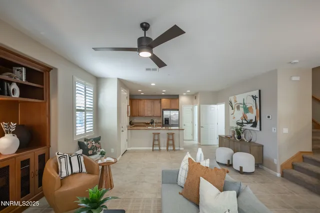 a living room with furniture and kitchen view