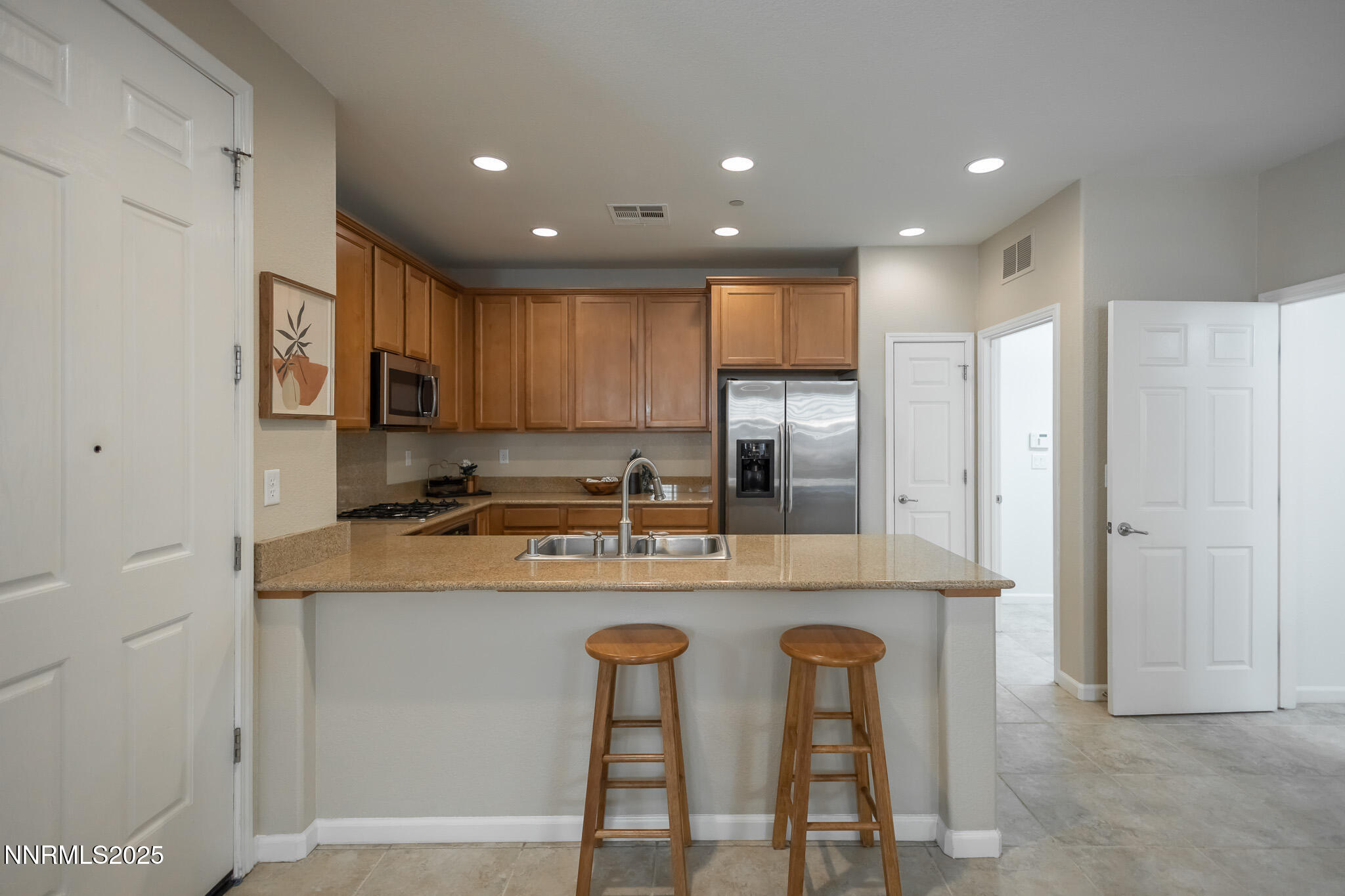 1715 Dark Horse Road, Unit B Reno, NV 89521 - Photo 10 of 39 a kitchen with stainless steel appliances granite countertop a table and chairs
