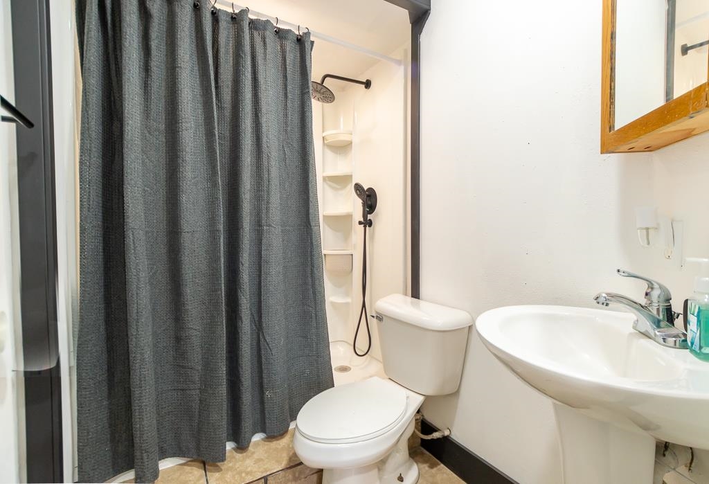 1045 North 2nd Street Rochelle, IL 61068 - Photo 7 of 15 a white toilet sitting next to a bathroom sink