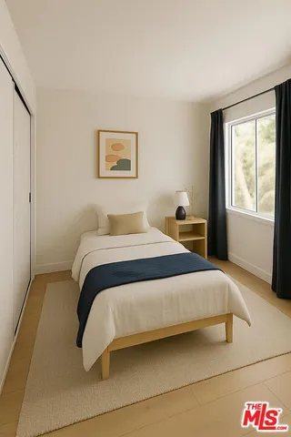 a bedroom with a bed and window