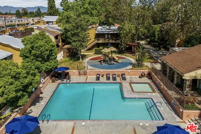 an aerial view of a house with swimming pool patio and outdoor seating