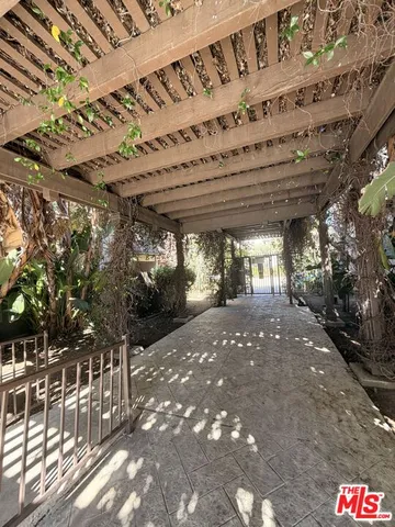 a view of porch with a table and chairs