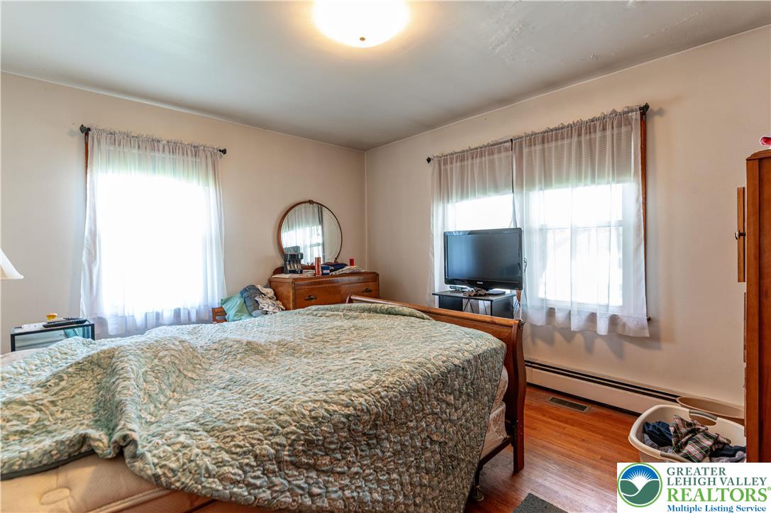 243 East Prospect Street Nazareth, PA 18064 - Photo 17 of 28 a bedroom with a bed and a flat tv screen on dresser