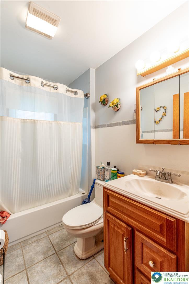 243 East Prospect Street Nazareth, PA 18064 - Photo 23 of 28 a bathroom with a sink a toilet and shower curtain