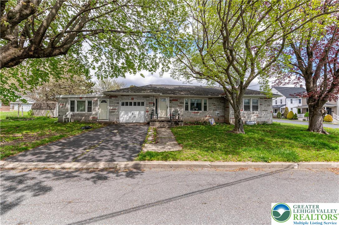 243 East Prospect Street Nazareth, PA 18064 - Photo 27 of 28 a front view of a house with a garden and tree