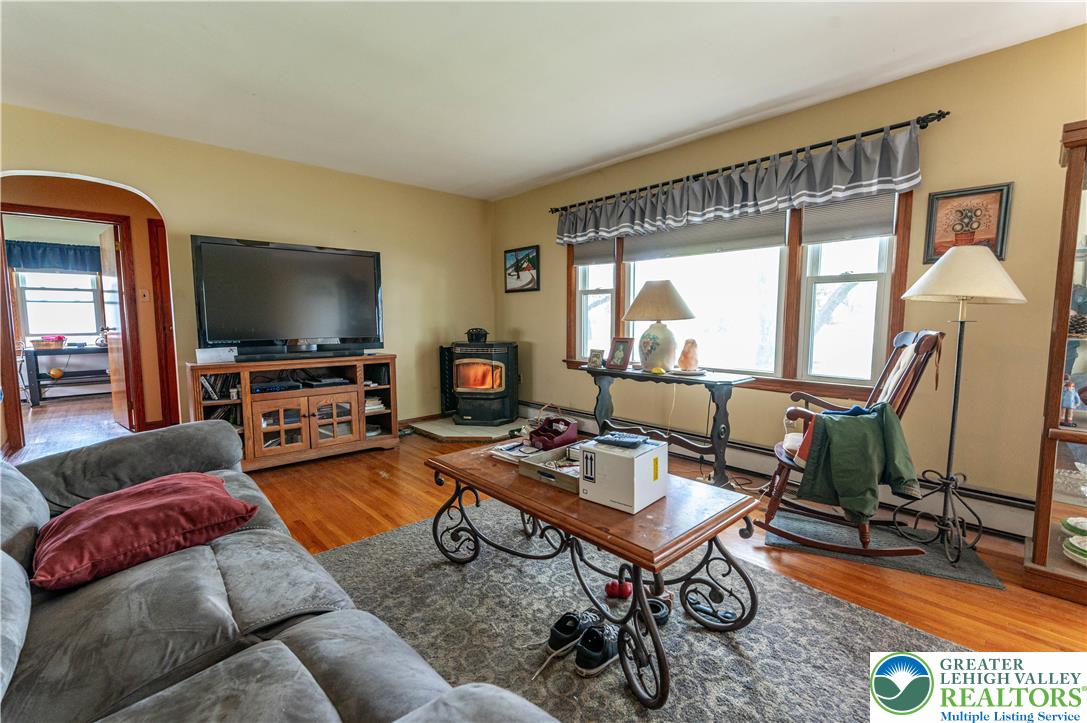 243 East Prospect Street Nazareth, PA 18064 - Photo 4 of 28 a living room with furniture a flat screen tv and a floor to ceiling window