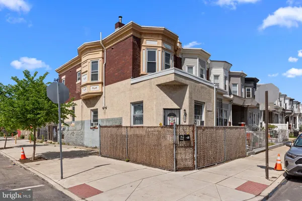 a front view of a residential apartment building with a yard