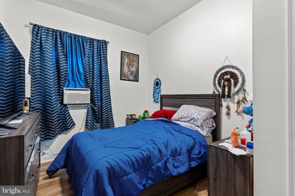 a bedroom with a bed and a painting on the wall