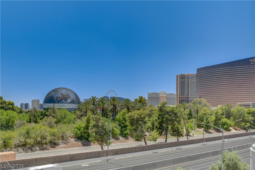 360 East Desert Inn Road, Unit 402 Las Vegas, NV 89109 - Photo 39 of 40 A vibrant cityscape offers distant views of prominent buildings and a clear blue sky.
