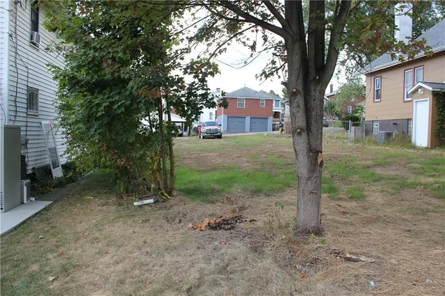 a view of a house with a tree in the yard