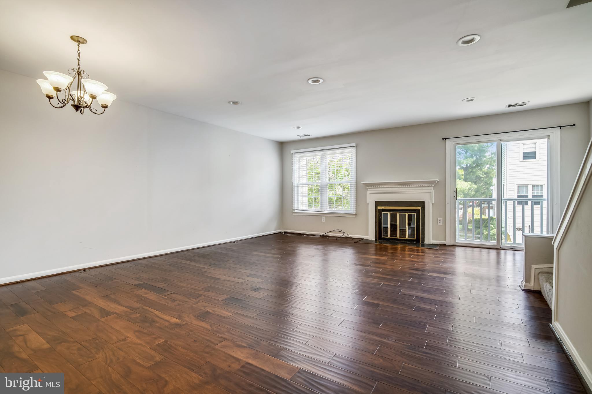 2241 Aberdeen Drive Crofton, MD 21114 - Photo 15 of 37 an empty room with wooden floor fireplace and windows