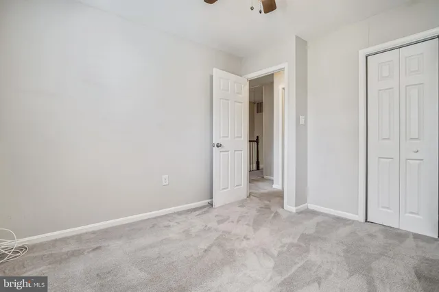 an empty room with closet area